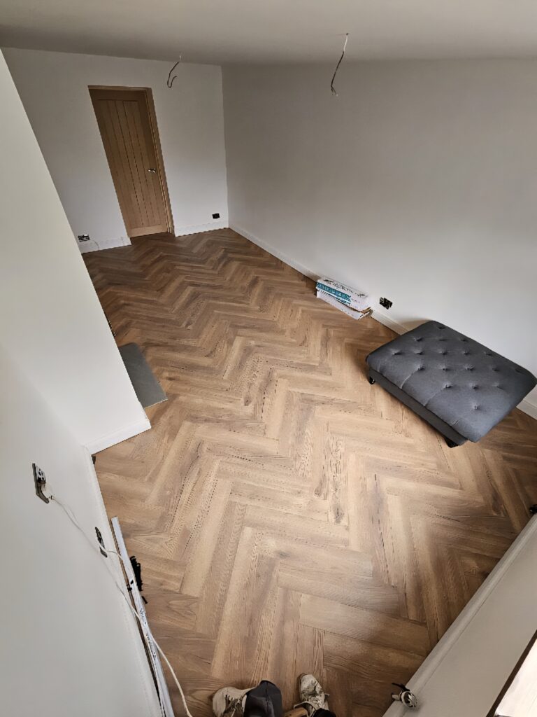 ​Herringbone wood floor installation completed by Renofox Construction in a Hinckley home.
