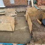 ​Poured concrete foundations and footings for a new home extension project by Renofox Construction in Hinckley.