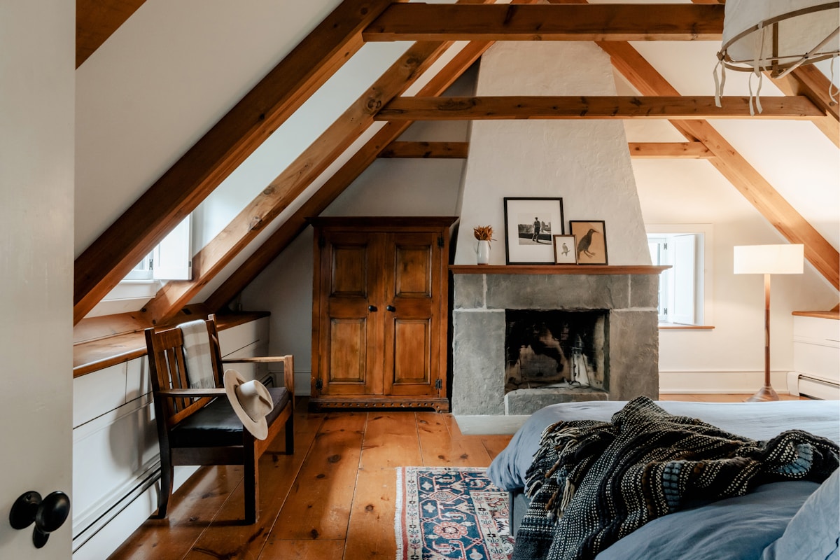 Converted loft bedroom with exposed wooden beams (reference photo)