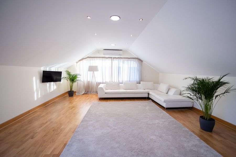 Modern converted loft space with sloped ceiling and contemporary furnishing (reference photo)